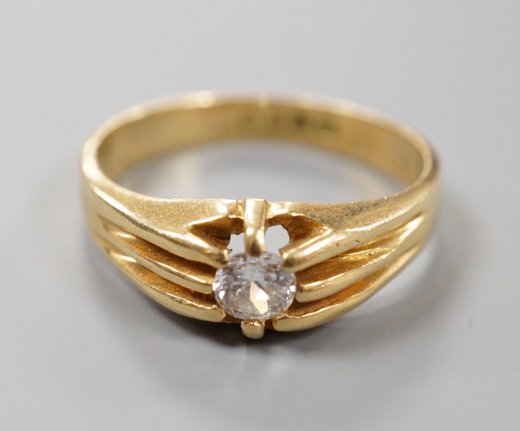 A late Victorian 18ct gold and claw set solitaire diamond ring, size, S/T, gross 6.3 grams.